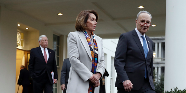 House Democratic leader Rep. Nancy Pelosi of California, and Senate Minority Leader Chuck Schumer, D-N.Y., walk to speak with reporters after a meeting with President Donald Trump on border security at the White House, Wednesday, Jan. 2, 2019, in Washington. (AP Photo/Evan Vucci)
