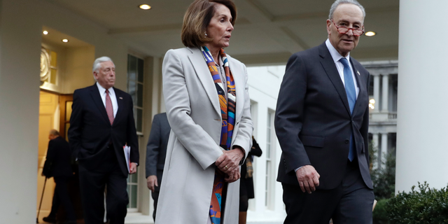 House Democratic leader Rep. Nancy Pelosi of California, and Senate Minority Leader Chuck Schumer, D-N.Y., walk to speak with reporters after a meeting with President Donald Trump on border security at the White House, Wednesday, Jan. 2, 2019, in Washington. (AP Photo/Evan Vucci)
