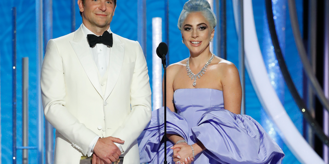 This image released by NBC shows Bradley Cooper, left, and Lady Gaga presenting the award for best actor in a TV comedy series at the 76th Annual Golden Globe Awards at the Beverly Hilton Hotel.