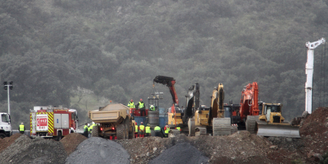 In this photo taken on Sunday, Jan. 20, 2019, drill and excavating machinery work on top of the mountain next to a deep borehole to reach a 2-year-old boy trapped there for six days near the town of Totalan in Malaga, Spain. Spanish officials say rescuers are making slow progress in exceptionally difficult conditions to reach a 2-year-old boy who fell into a narrow, deep borehole in the countryside eight days ago.