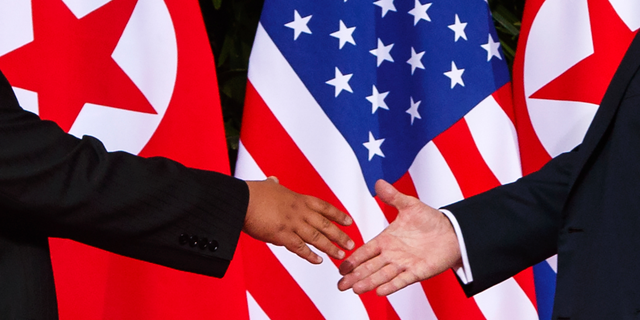 PresidentTrump reaches to shake hands with North Korea leader Kim Jong Un at the Capella resort on Sentosa Island in Singapore in 2018.