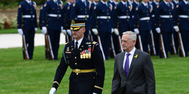 FILE - In this Sept. 21, 2018, file photo, Defense Secretary Jim Mattis reviews the troops during the 2018 POW/MIA National Recognition Day Ceremony at the Pentagon. Outgoing Defense Secretary Jim Mattis is quoting President Abraham Lincoln in a farewell message to defense employees, urging them to stay focused on their mission. (AP Photo/Susan Walsh, File)