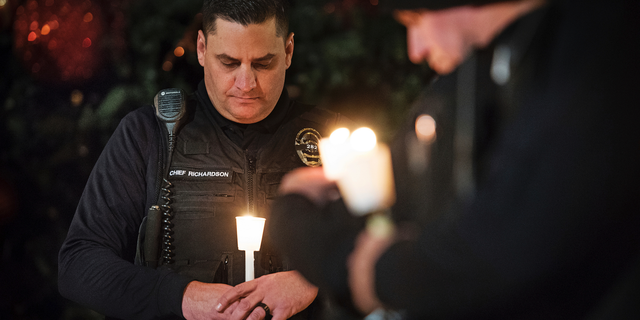 FILE - In this Friday, Dec. 28, 2018 file photo, Newman Police Chief Randy Richardson and hundreds of others attend a vigil in memory of police Cpl. Ronil Singh in Newman, Calif. The Northern California police officer was gunned down during a traffic stop the day after Christmas 2018. (Andy Alfaro/The Modesto Bee via AP,File)