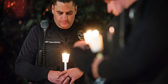 FILE - In this Friday, Dec. 28, 2018 file photo, Newman Police Chief Randy Richardson and hundreds of others attend a vigil in memory of police Cpl. Ronil Singh in Newman, Calif. The Northern California police officer was gunned down during a traffic stop the day after Christmas 2018. (Andy Alfaro/The Modesto Bee via AP,File)
