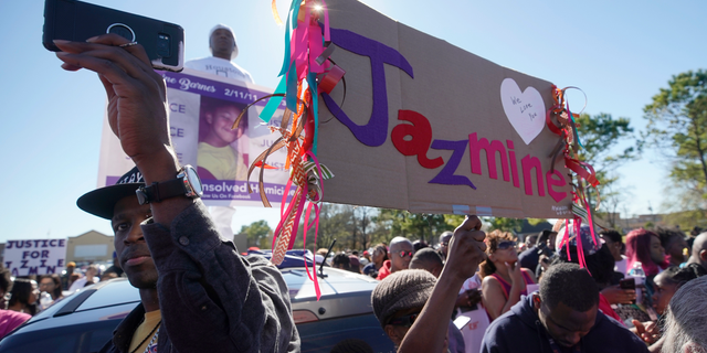 People attend a community rally outside a Walmart on East Sam Houston Pkwy N in Houston on Saturday, Jan. 5, 2019 for 7-year-old Jazmine Barnes, who was killed on Sunday. Jazmine was shot to death nearby while riding in a car with her mother and three sisters. (Melissa Phillip/Houston Chronicle via AP)