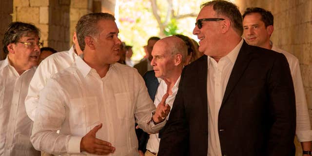 In this photo released by the Colombia's Presidency U.S. Secretary of State Mike Pompeo, right, and Colombia's President Ivan Duque talk during a meeting at the Presidential Guest House in Cartagena, Colombia, Wednesday, Jan. 2, 2019. (Nicolas Galeano/Colombia's Presidency via AP)