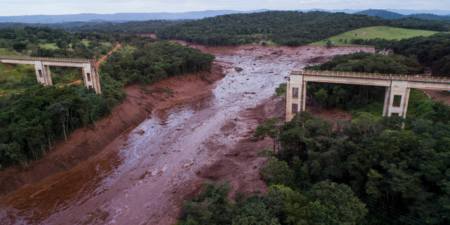 An aerial view shows a collapsed bridge caused by flooding triggered by a dam collapse near Brumadinho, Brazil, Friday, Jan. 25, 2019.