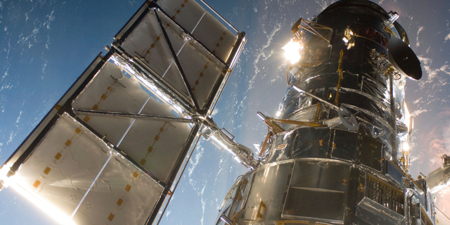 This May 13, 2009 photo shows the Hubble Space Telescope from the space shuttle Atlantis, orbiting the Earth.