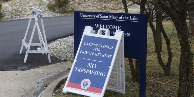 A sign outside the Mundelein Seminary asks the faithful to pray for U.S. based Roman Catholic bishops gathering there for a weeklong prayer retreat, Wednesday, Jan. 2, 2019, in Mundelein, Ill. The bishops are gathering to reflect on the church sexual abuse scandal ahead of a summit of the world's bishops next month at the Vatican aimed at forging a comprehensive response to the crisis. (AP Photo/Teresa Crawford)