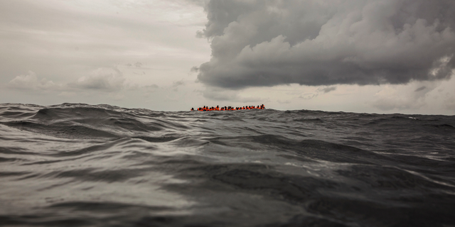 In this Feb. 18, 2018, file photo, refugees and migrants wait to be rescued by aid workers 60 miles north of Al-Khums, Libya. (AP Photo/Olmo Calvo, File )