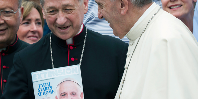 FILE - In this Sept. 2, 2015, file photo, Pope Francis, right, salutes Chicago Archbishop Blase Joseph Cupich at the end of his weekly general audience in St. Peter's Square at the Vatican. Pope Francis, in an eight-page letter addressed to U.S. bishops meeting in Mundelein, Ill., and released to the media Thursday, Jan. 3, 2019, is encouraging bishops to unify as the Catholic church deals with a "crisis of credibility" stemming from the clergy sex abuse scandal. (AP Photo/Alessandra Tarantino, File)