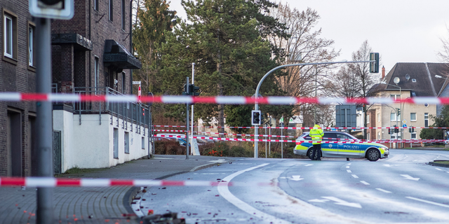 The Police blocks a road in Bottrop, Germany, Tuesday, Jan. 1, 2019. A man has been arrested in Germany after ploughing his car into a crowd of people, injuring at least four, in what appears to have been an intentional attack directed at foreigners, police said Tuesday.  (Marcel Kusch/dpa via AP)