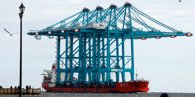 Spectators watch a Chinese ship carrying giant cranes approach the entrance to Hampton Roads in Virginia.