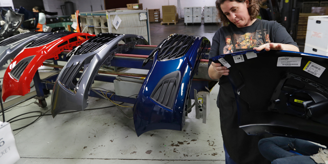 FILE- In this Nov. 28, 2018, file photo Crystal Odum inspects the front end of a General Motors Chevrolet Cruze at Jamestown Industries in Youngstown, Ohio. On Thursday, Jan. 3, 2019, the Institute for Supply Management, a trade group of purchasing managers, issues its index of manufacturing activity for December. (AP Photo/Tony Dejak, File)