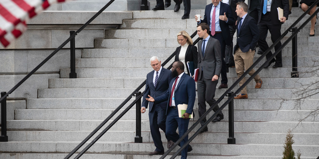 Vice President Mike Pence, left, White House legislative affairs aide Ja'Ron Smith, Homeland Security Secretary Kirstjen Nielsen, second row left, White House Senior Adviser Jared Kushner, and others, walk down the steps of the Eisenhower Executive Office building, on the White House complex, after a meeting with staff members of House and Senate leadership, Saturday, Jan. 5, 2019, in Washington. (AP Photo/Alex Brandon)