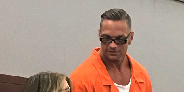 In this Aug. 17, 2017, file photo, Nevada death row inmate Scott Raymond Dozier, right, confers with Lori Teicher, a federal public defender involved in his case, during an appearance in Clark County District Court in Las Vegas. (AP Photo/Ken Ritter, File)