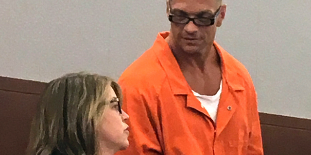 In this Aug. 17, 2017, file photo, Nevada death row inmate Scott Raymond Dozier, right, confers with Lori Teicher, a federal public defender involved in his case, during an appearance in Clark County District Court in Las Vegas. (AP Photo/Ken Ritter, File)