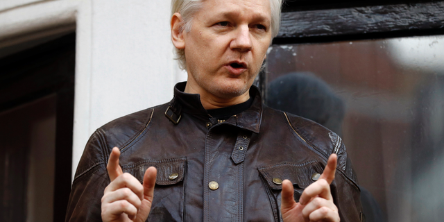 FILE - In this May 19, 2017 file photo, WikiLeaks founder Julian Assange gestures to supporters outside the Ecuadorian embassy in London, where he has been in self imposed exile since 2012. A federal judge has rejected a request to unseal criminal charges against Assange that were mistakenly revealed in another case. In a ruling issued Wednesday, Jan. 30, 2019, U.S. District Judge Leonie Brinkema said that free-press advocates seeking to unseal the charges have no proof Assange has actually been charged. (AP Photo/Frank Augstein, File)