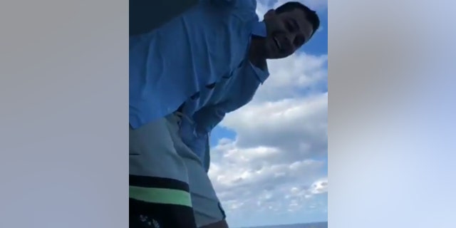 Nick Naydev, 27, shared footage of his friends helping him up on the railing before he jumps from the Symphony of the Seas.