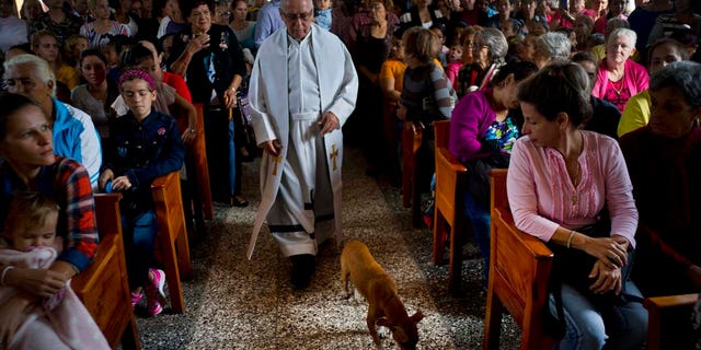 Father Cirilo Castro takes part in the consecration Mass of the Sagrado Corazon de Jesus, or Sacred Heart, Catholic church, in Sandino, Cuba, Saturday, Jan. 26, 2019. (AP Photo/Ramon Espinosa)