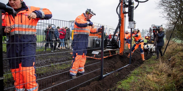 Workers erect a fence along the Denmark Germany border at Padborg, Denmark, Monday Jan. 28, 2019. (Frank Cilius/Ritzau Scanpix via AP)