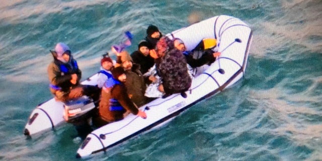 This image provided by the Marine Nationale (French Navy) shows migrants aboard a rubber boat after being intercepted by French authorities, off the port of Calais, northern France last month. (Marine Nationale via AP)