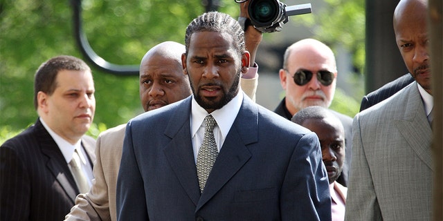 R&B singer R. Kelly (L) arrives at the Cook County courthouse where jury selection is scheduled to begin for his child pornography trial May 9, 2008 in Chicago, Illinois. Kelly has been accused of videotaping himself having sex with a girl believed to be as young as 13 years old. Kelly faces up to 15 years in prison if convicted.