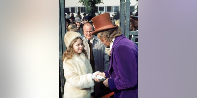 From right to left, actors Gene Wilder as Willy Wonka, Roy Kinnear as Mr. Salt and Julie Dawn Cole as Veruca Salt in the movie 'Willy Wonka &';  the Chocolate Factory.'