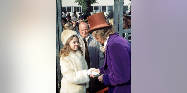 From right to left, actors Gene Wilder as Willy Wonka, Roy Kinnear as Mr. Salt and Julie Dawn Cole as Veruca Salt in the film 'Willy Wonka & the Chocolate Factory.'
