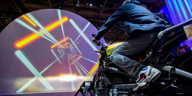 A man tries out a Harley-Davidson LiveWire electric motorcycle at the Panasonic exhibit during CES 2019 in Las Vegas, Nevada on Jan. 8, 2019.