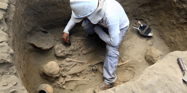 File photo - Ancient mass graves have also been discovered in the area. Here, an archaeologist works on an excavation site where human remains dating more than 1,500 years were found, in the northern coastal town of Huanchaco, in Peru on March 21, 2018.