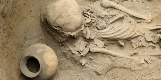 File photo - This picture is a view of human remains and pottery items dating more than 1,500 years, found at an excavation site in the northern coastal town of Huanchaco, in Peru on March 21, 2018.