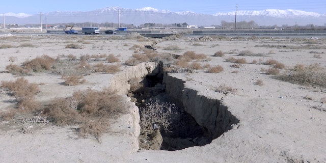 This frame grab from video taken on Jan. 8, 2019, shows fissure caused by drought and excessive water pumping in Malard, west of Tehran, Iran. Fissures appear along roads, while massive holes open up in the countryside, their gaping maws a visible sign from the air of something Iranian authorities now openly acknowledge: The area around the capital Tehran is literally sinking.