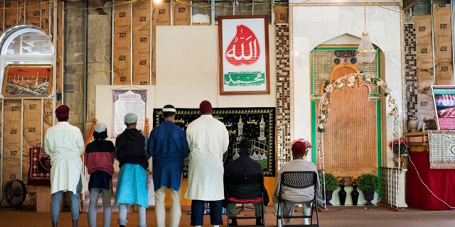In this Sept. 7, 2017 photo, men pray at the mosque at Islamberg in Tompkins, N.Y.