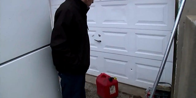 Donald Clark shows where a bullet pierced his garage in Kansas City, Mo. after celebratory gunfire on New Year's Day.