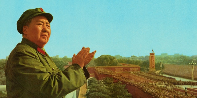 Peking, China: General view of Mao Zedong, the late Chinese Party Communist Chairman, applauding as he stands on a platform overlooking a crowd.