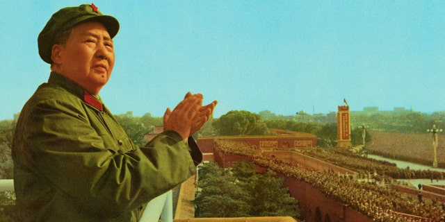 Peking, China: General view of Mao Zedong, the late Chinese Party Communist Chairman, applauding as he stands on a platform overlooking a crowd.
