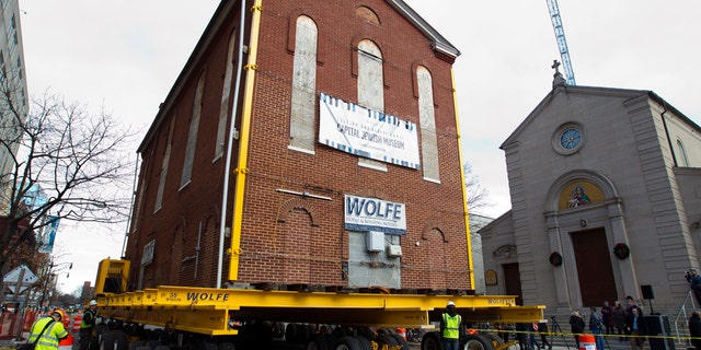 Workers move Adas Israel Synagogue, the oldest synagogue in Washington, down the street on Wednesday, Jan. 9, 2019, in Washington. The synagogue will be part of the new Capital Jewish Museum. (AP Photo/Jose Luis Magana)
