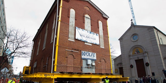 Workers move Adas Israel Synagogue, the oldest synagogue in Washington, down the street on Wednesday, Jan. 9, 2019, in Washington. The synagogue will be part of the new Capital Jewish Museum. (AP Photo/Jose Luis Magana)