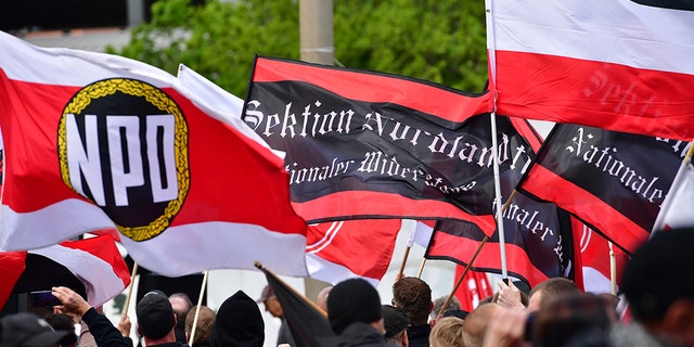 The flags of "Sektion Nordland" and flags of the far-right NPD political party are seen while gathering to march on May Day on May 1, 2018 in Erfurt, Germany.