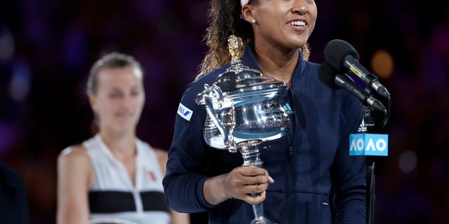 Japan's Naomi Osaka holds her trophy after defeating Petra Kvitova, left, of the Czech Republic during the women's singles final at the Australian Open tennis championships in Melbourne, Australia, Saturday, Jan. 26, 2019.