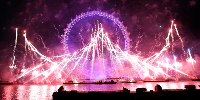 Fireworks explode over the London Eye during the New Year's eve celebrations after midnight in London, Tuesday, Jan. 1, 2019.(AP Photo/Kirsty Wigglesworth)