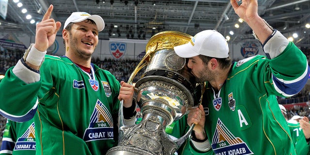 Oleg Saprykin, #91 of the Salavat Yulaev Ufa, and Alexander Radulov, #47 of the Salavat Yulaev Ufa, hoist the Gagarin Cup after the Salavat Yulaev Ufa defeated the Atlant Mytishchi 3-2 and won the Gagarin Cup in Game Five of the 2011 KHL Gagarin Cup Final on April 16, 2011 at the Arena Ufa in Ufa, Russia.