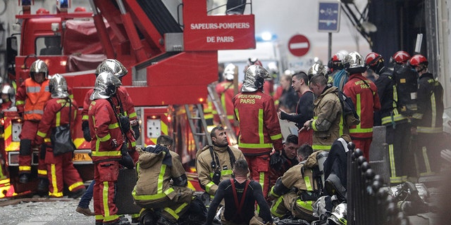 Firefighters rest in the street after the explosion of a bakery on the corner of the streets Saint-Cecile and Rue de Trevise in central Paris on January 12, 2019.