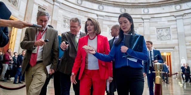   Nancy Pelosi, Speaker of the House of Representatives, California, in the center Addresses reporters as she leaves an event with federal employees maimed as part of the partial government closure on Wednesday, Jan. 16. 2019, on Capitol Hill in Washington (Photo AP / Andrew Harnik) 