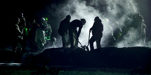 Staff of Pemex, Petroleos Mexicanos, works the area of a oil pipeline explosion in Tlahuelilpan, Hidalgo state, Mexico, Saturday, Jan. 19, 2019.