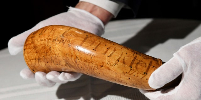 The Nowlin Powder Horn, carved for soldier Lt. Abel Prindel in 1757, is displayed during a news conference, Tuesday, Jan. 15, 2019, at the Dearborn Historical Museum in Dearborn, Mich. (Robin Buckson/Detroit News via AP)