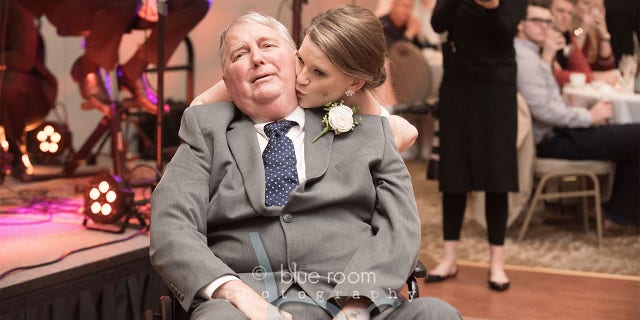 The bride kisses her father on the dance floor. (Blue Room Photography)