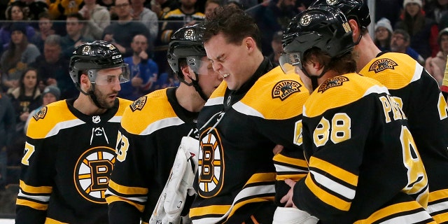 Boston Bruins goaltender Tuukka Rask (40) is helped off the ice after taking a hit on a goal by New York Rangers center Filip Chytil during the first period of an NHL hockey game, Saturday, Jan. 19, 2019, in Boston. (Associated Press)