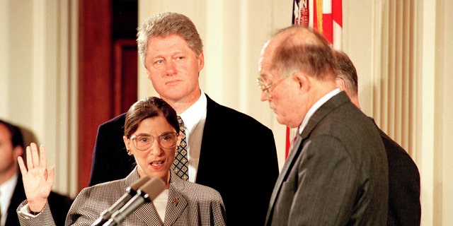 Supreme Court Chief Justice William Rehnquist, right, administers the oath to defend the Constitution to Ruth Bader Ginsburg as President Bill Clinton looks on in the East Room of the White House in Washington, D.C., Tuesday, Aug. 10, 1993. (Associated Press)